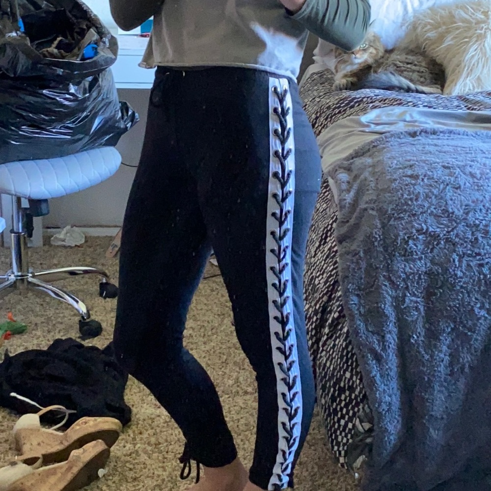 Black joggers with a cross cross design